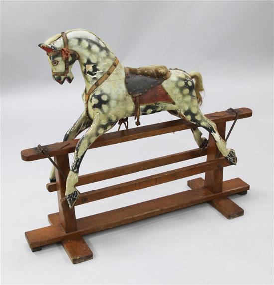 An Edwardian carved wood rocking horse, H.2ft 8in. Overall L.3ft 3in.